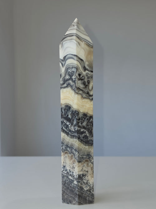 Luxury Chocolate Calcite Tower by Stone and Bloom featuring rich caramel and cream natural banding, Chocolate Calcite Tower, Crystal Tower, Luxury Crystal Décor, Statement Crystal Piece, Stone and Bloom. Home Styling, Natural Stone, On Trend