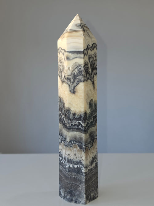 Luxury Chocolate Calcite Tower by Stone and Bloom featuring rich caramel and cream natural banding, Chocolate Calcite Tower, Crystal Tower, Luxury Crystal Décor, Statement Crystal Piece, Stone and Bloom. Home Styling, Natural Stone, On Trend