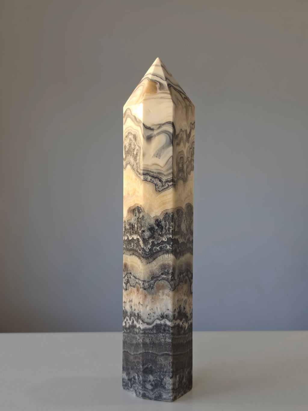 Luxury Chocolate Calcite Tower by Stone and Bloom featuring rich caramel and cream natural banding, Chocolate Calcite Tower, Crystal Tower, Luxury Crystal Décor, Statement Crystal Piece, Stone and Bloom. Home Styling, Natural Stone, On Trend