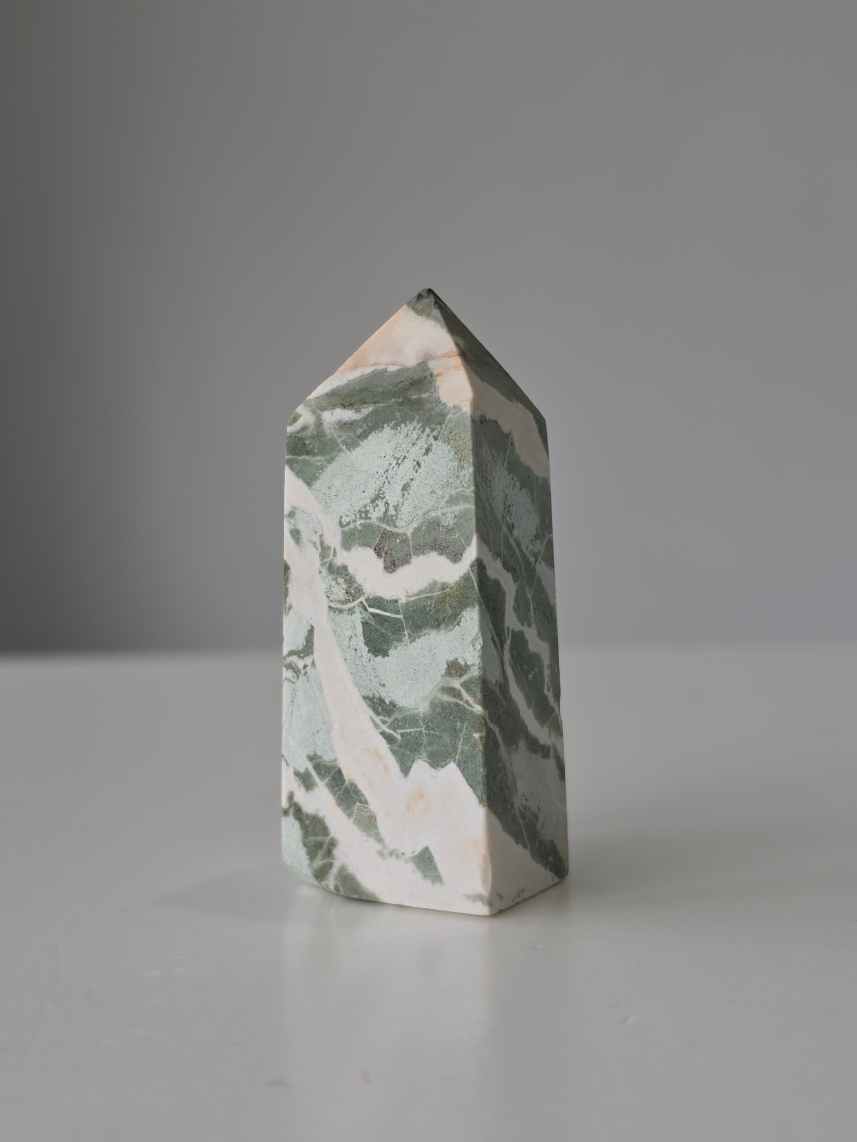 High quality Ocean Jasper crystal tower with calming sage green hues, intricate natural patterns, and elegant statement décor styling by Stone and Bloom.