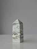 High quality Ocean Jasper crystal tower with calming sage green hues, intricate natural patterns, and elegant statement décor styling by Stone and Bloom.