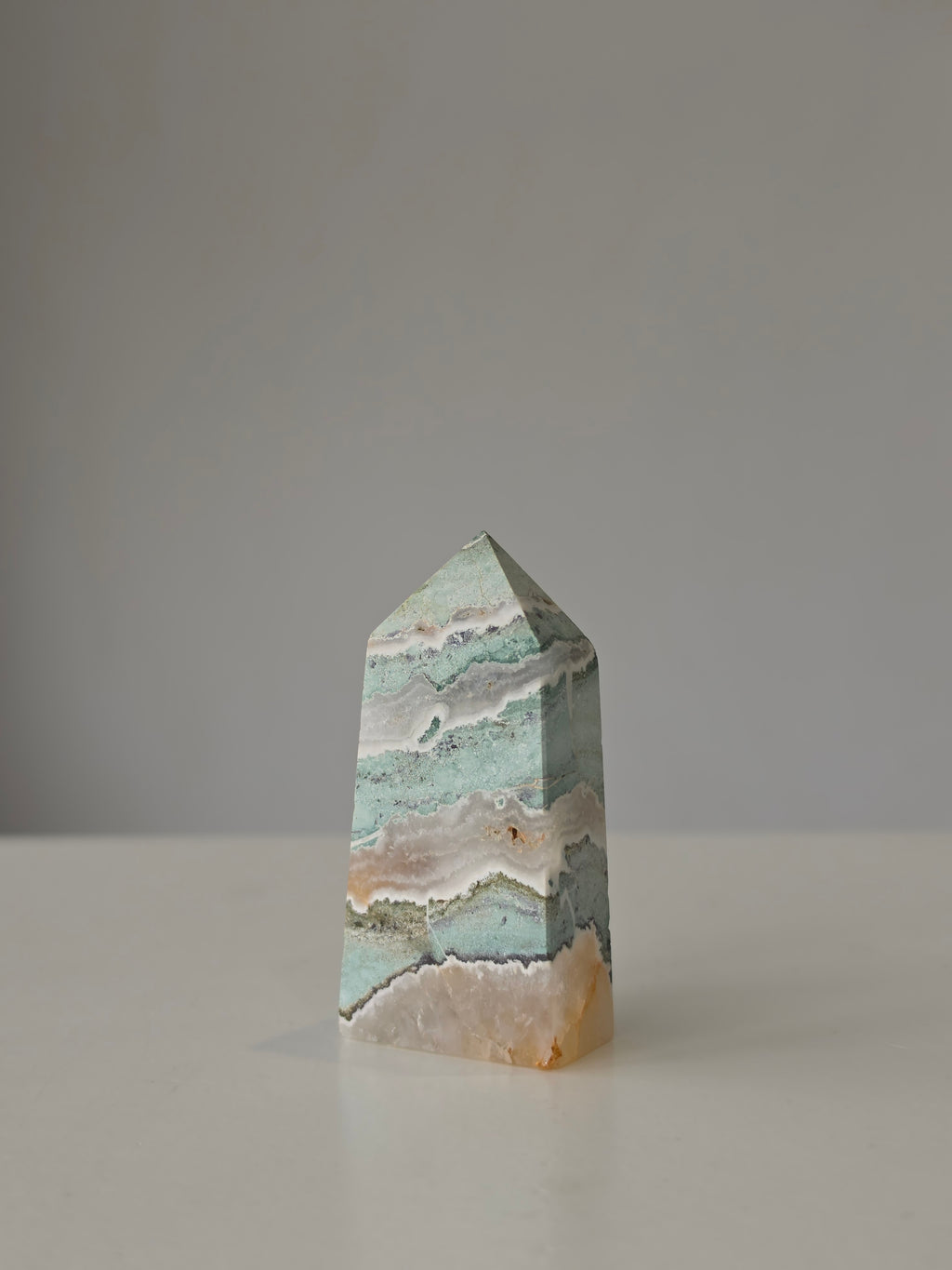 High quality Ocean Jasper crystal tower with calming sage green hues, intricate natural patterns, and elegant statement décor styling by Stone and Bloom.