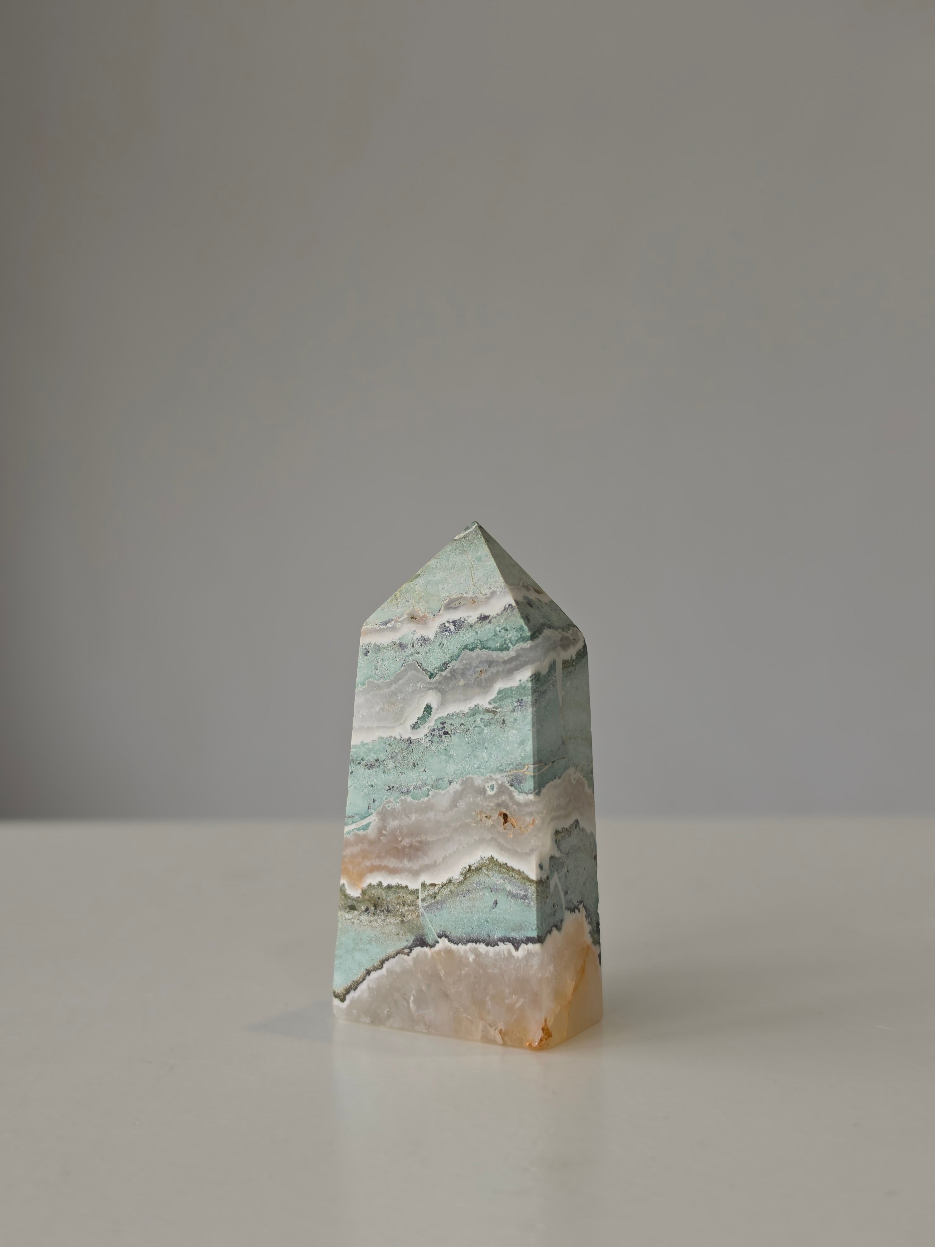 High quality Ocean Jasper crystal tower with calming sage green hues, intricate natural patterns, and elegant statement décor styling by Stone and Bloom.