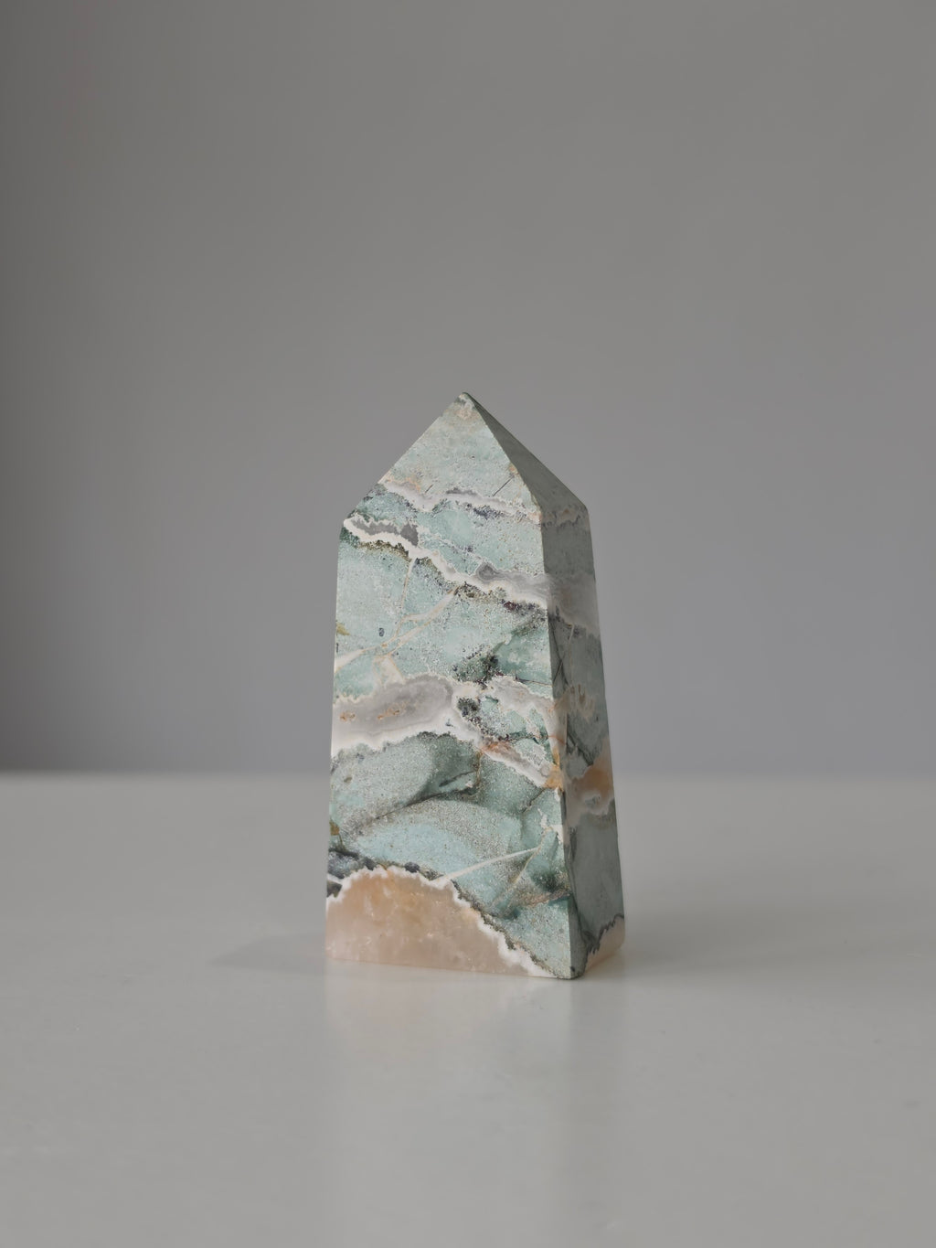High quality Ocean Jasper crystal tower with calming sage green hues, intricate natural patterns, and elegant statement décor styling by Stone and Bloom.