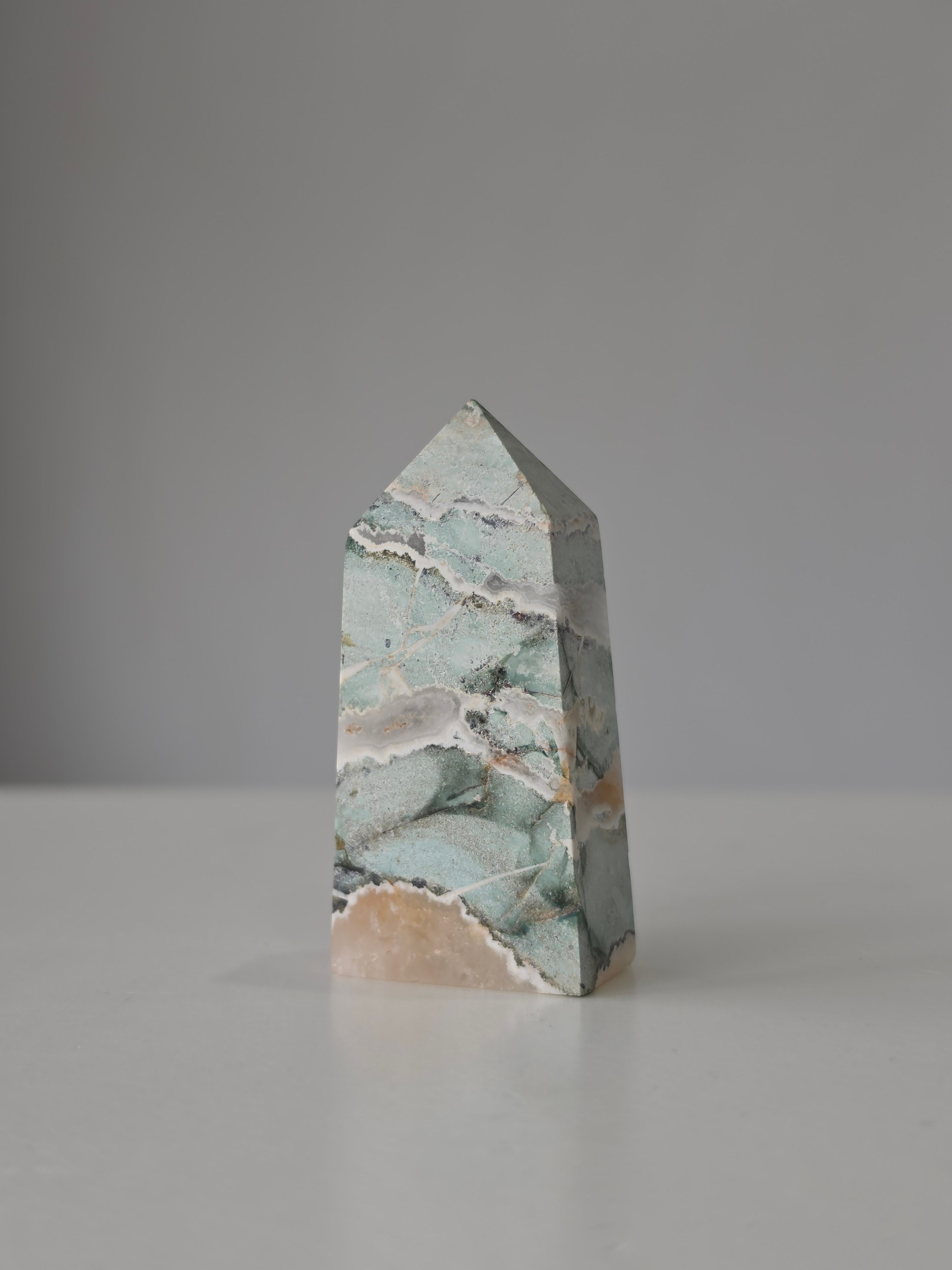 High quality Ocean Jasper crystal tower with calming sage green hues, intricate natural patterns, and elegant statement décor styling by Stone and Bloom.