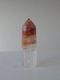 Luxury Fire Quartz Tower showcasing striking red inclusions and exceptional natural clarity. A premium statement piece curated by Stone and Bloom.