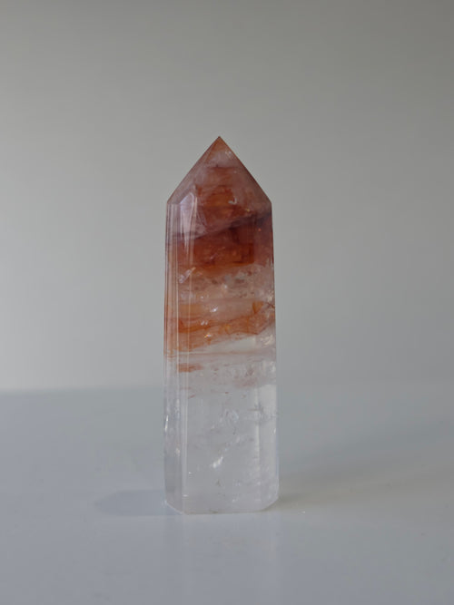 Luxury Fire Quartz Tower showcasing striking red inclusions and exceptional natural clarity. A premium statement piece curated by Stone and Bloom.