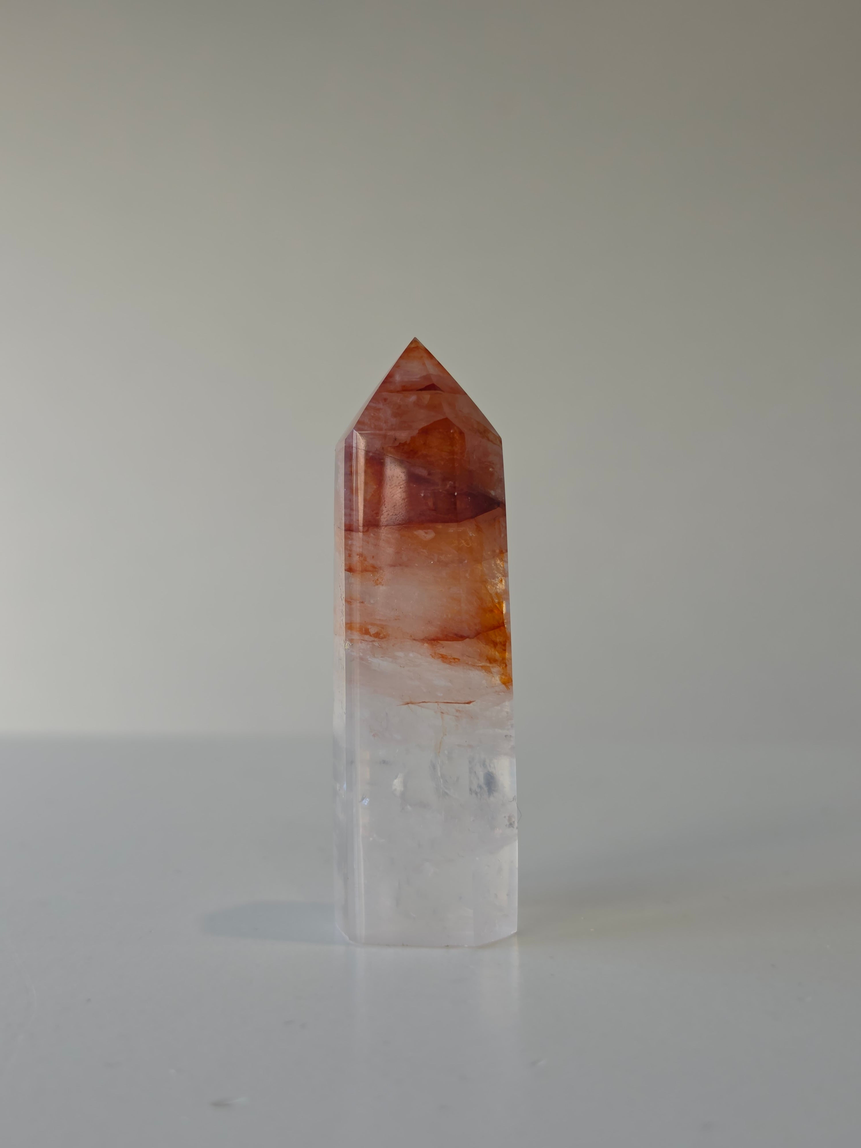 Luxury Fire Quartz Tower showcasing striking red inclusions and exceptional natural clarity. A premium statement piece curated by Stone and Bloom.