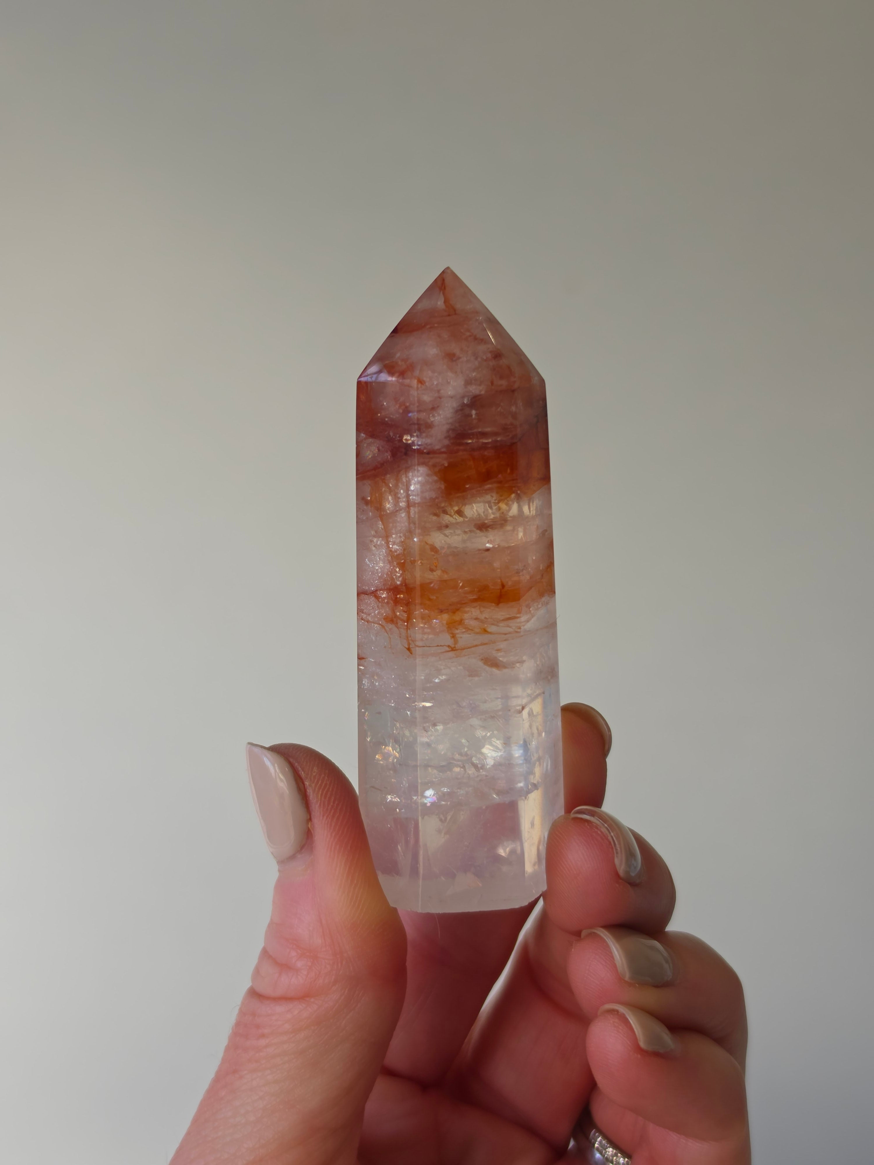Luxury Fire Quartz Tower showcasing striking red inclusions and exceptional natural clarity. A premium statement piece curated by Stone and Bloom.