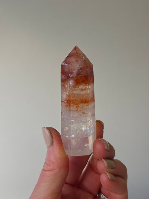 Luxury Fire Quartz Tower showcasing striking red inclusions and exceptional natural clarity. A premium statement piece curated by Stone and Bloom.