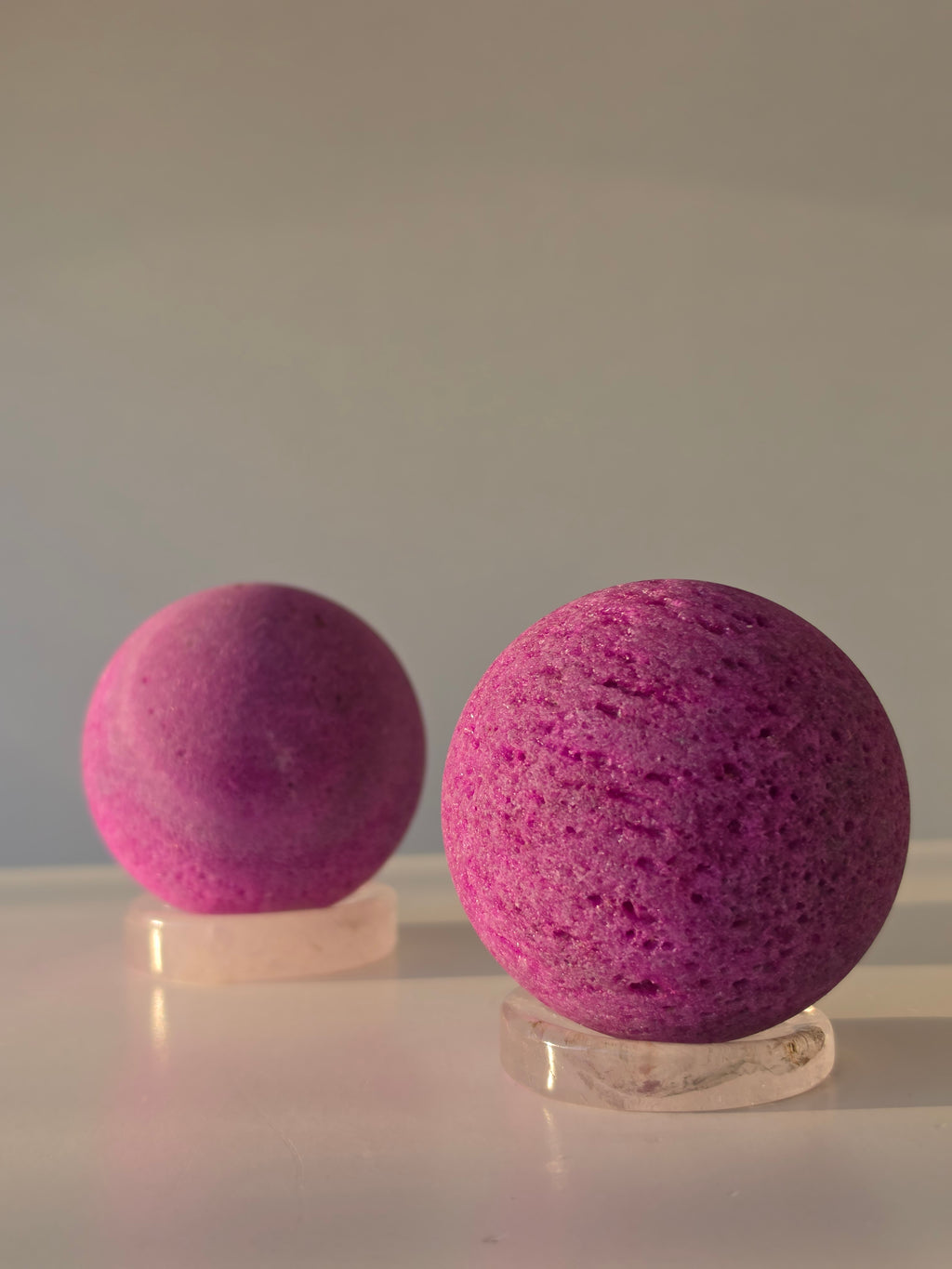 Luxury Natural Ruby Sphere by Stone and Bloom featuring rich raspberry and crimson tones, unique natural mineral formations, and exceptional statement décor appeal.