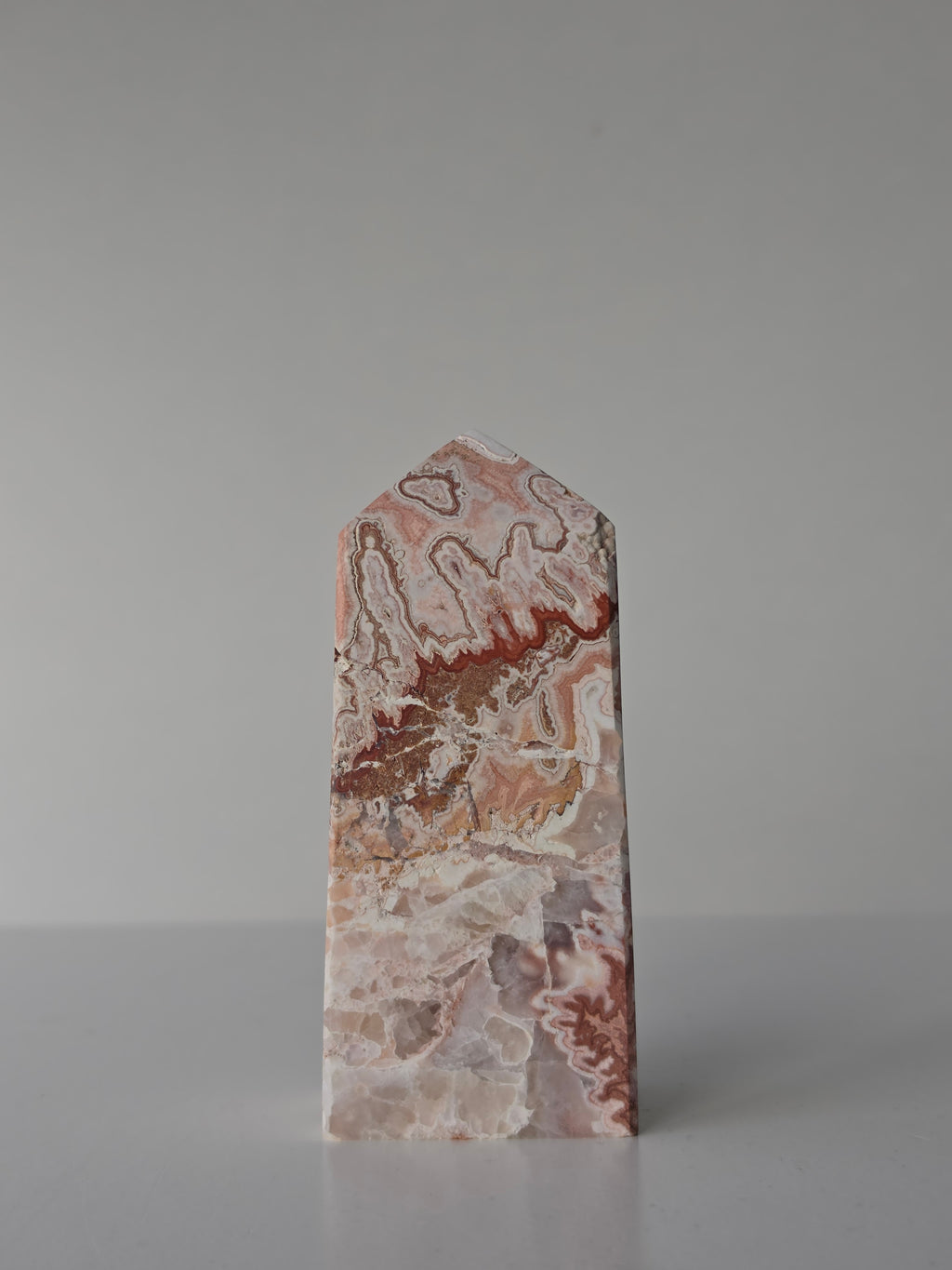 High quality Pink Mexican Lace Agate crystal tower with soft rose tones, natural lace patterns, and elegant statement décor styling by Stone and Bloom