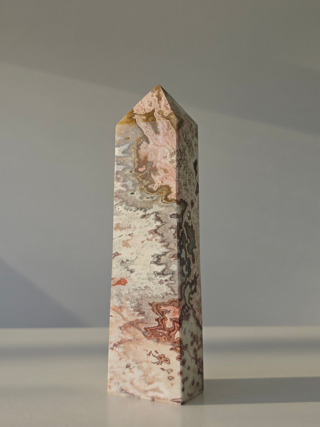 High quality Pink Mexican Lace Agate crystal tower with soft rose tones, natural lace patterns, and elegant statement décor styling by Stone and Bloom