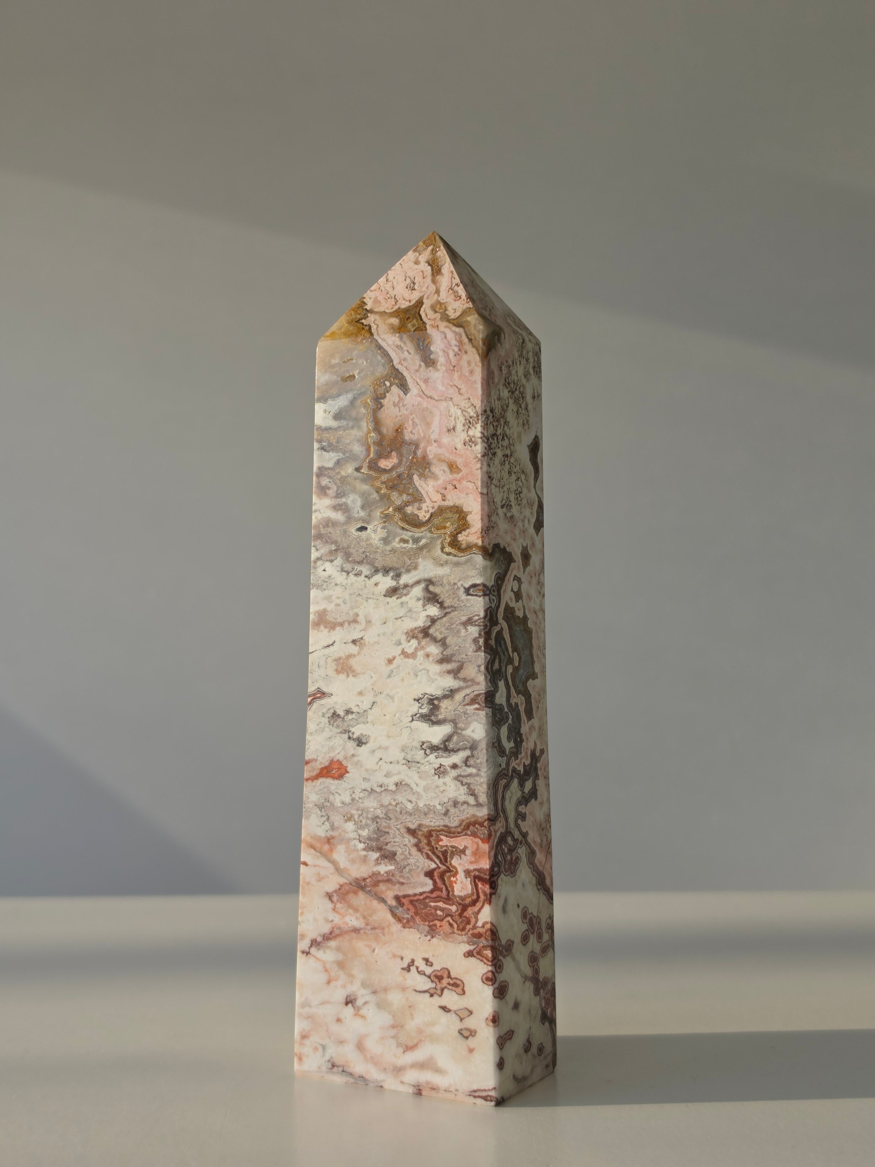 High quality Pink Mexican Lace Agate crystal tower with soft rose tones, natural lace patterns, and elegant statement décor styling by Stone and Bloom