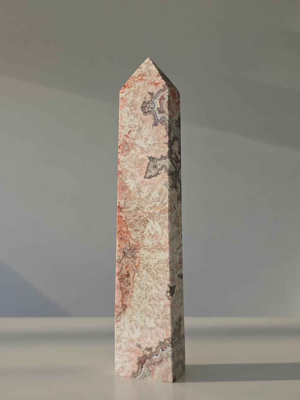 High quality Pink Mexican Lace Agate crystal tower with soft rose tones, natural lace patterns, and elegant statement décor styling by Stone and Bloom
