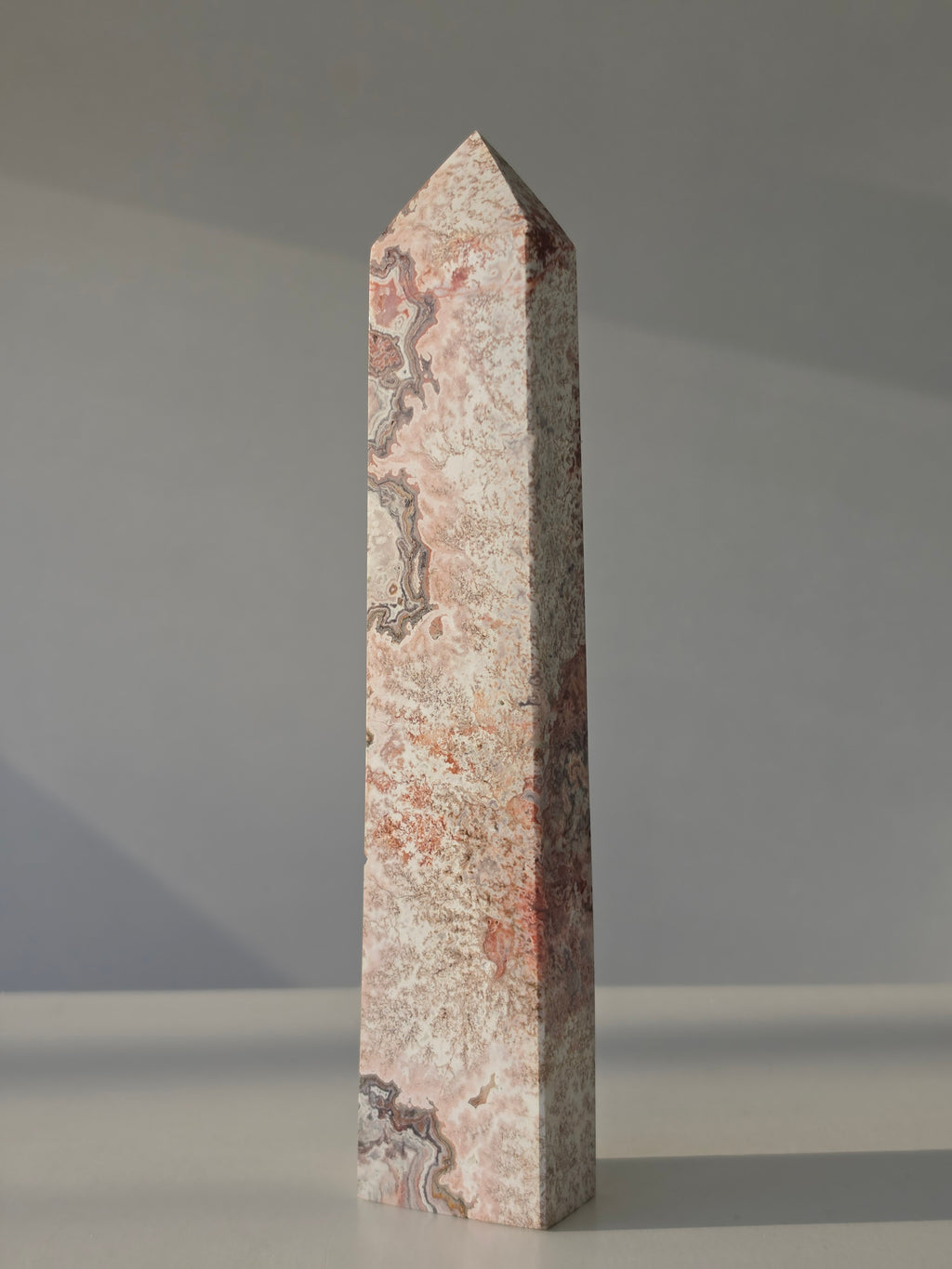 High quality Pink Mexican Lace Agate crystal tower with soft rose tones, natural lace patterns, and elegant statement décor styling by Stone and Bloom