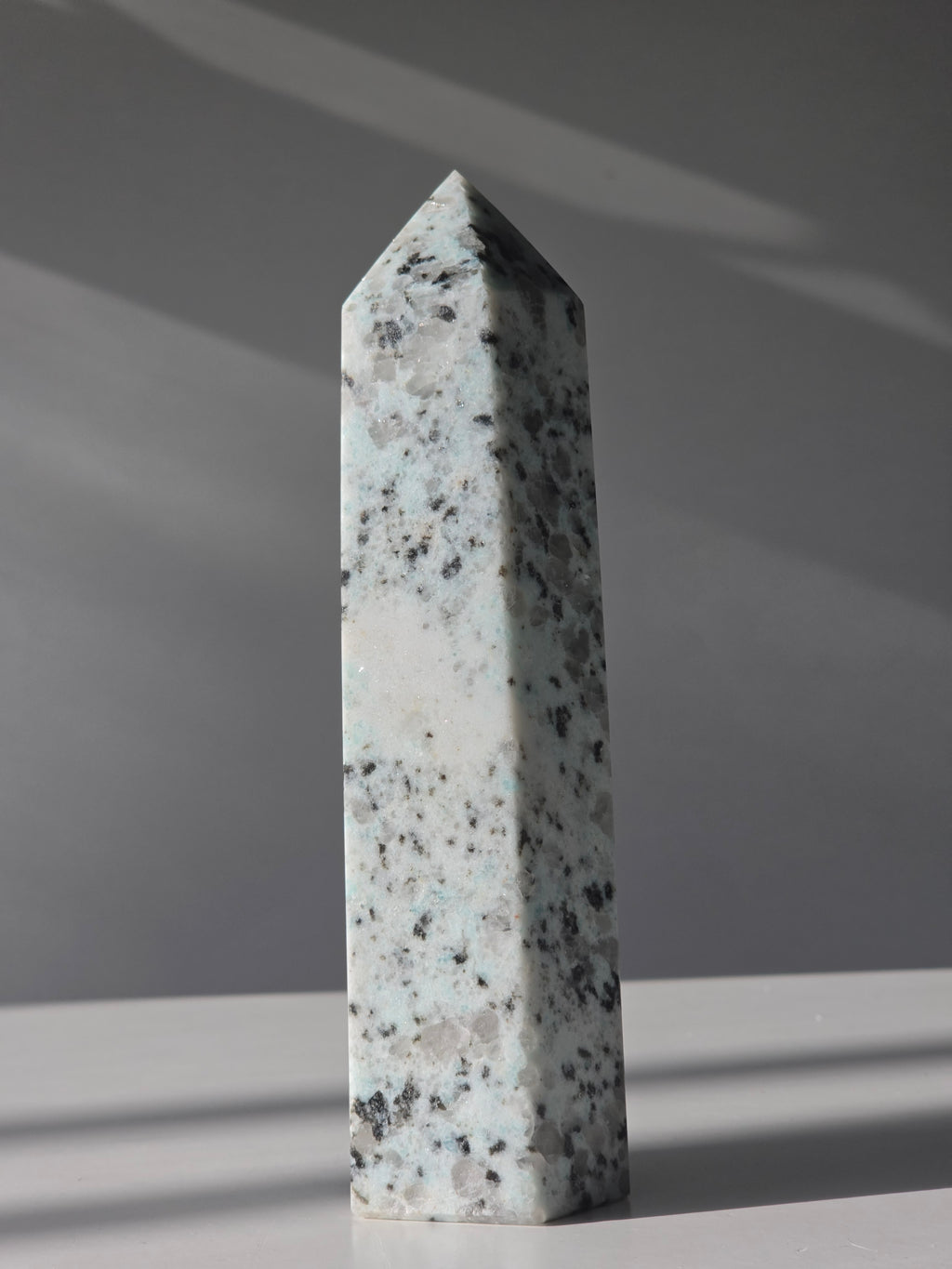 Luxury Kiwi Jasper Tower by Stone and Bloom featuring soft mint green tones, natural quartz inclusions, and charcoal mineral speckling polished into a premium statement piece.