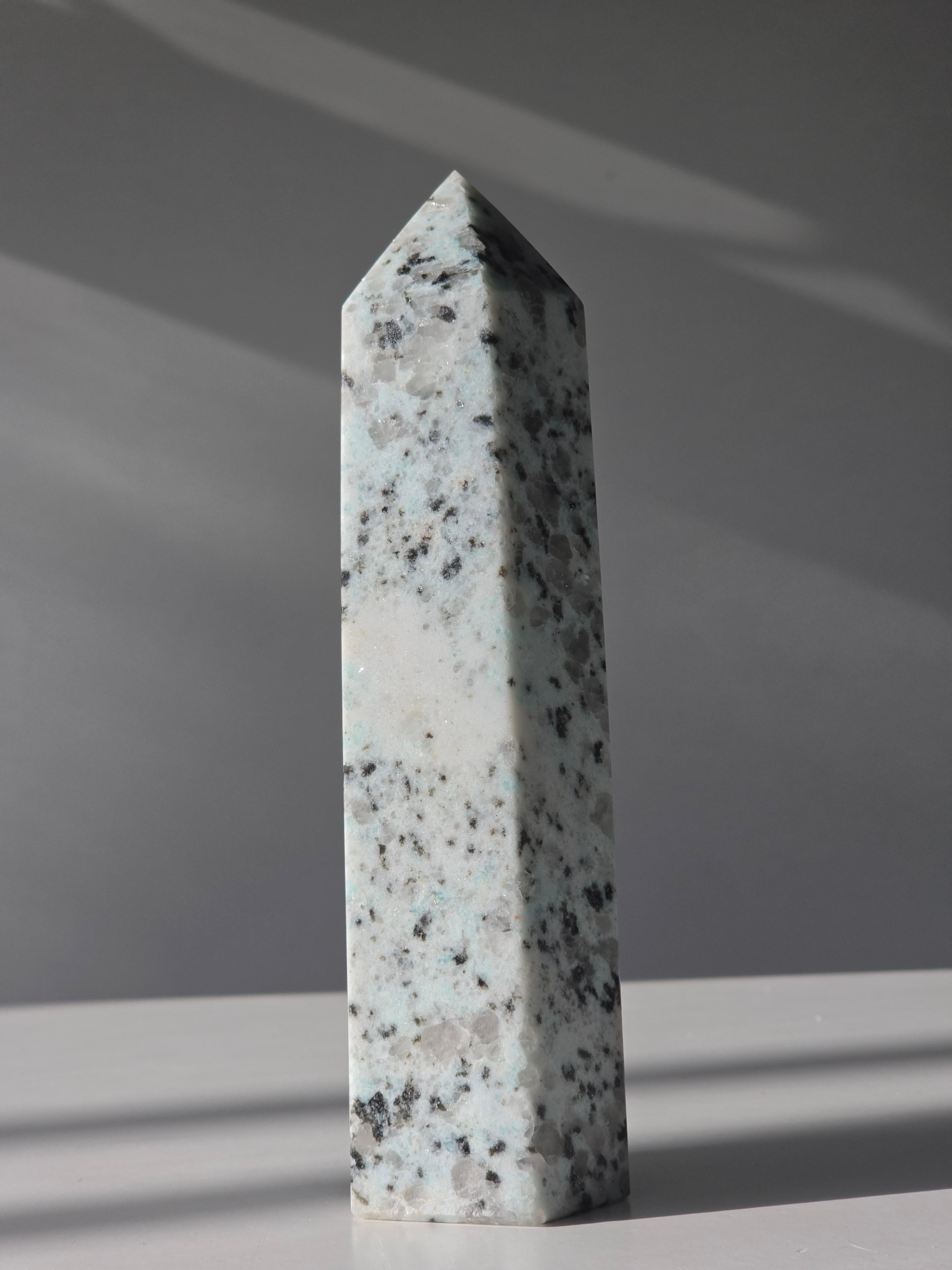 Luxury Kiwi Jasper Tower by Stone and Bloom featuring soft mint green tones, natural quartz inclusions, and charcoal mineral speckling polished into a premium statement piece.