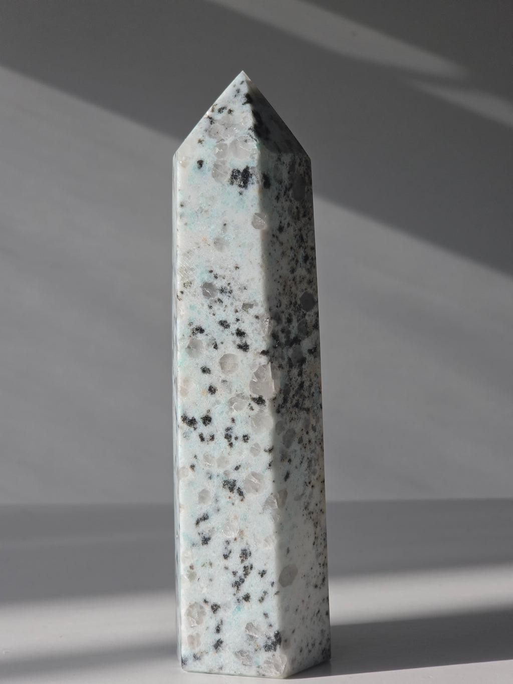 Luxury Kiwi Jasper Tower by Stone and Bloom featuring soft mint green tones, natural quartz inclusions, and charcoal mineral speckling polished into a premium statement piece.