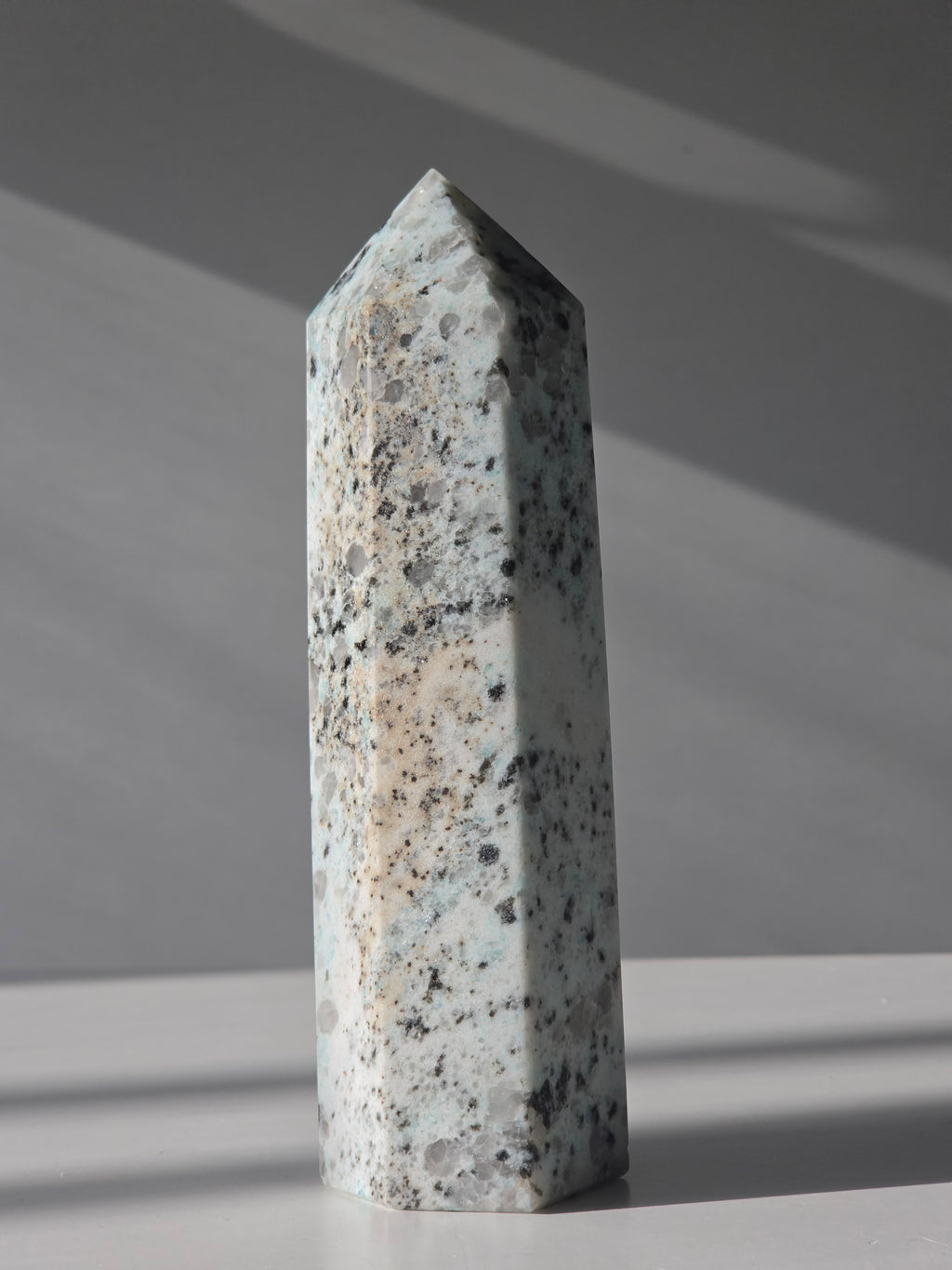 Luxury Kiwi Jasper Tower by Stone and Bloom featuring soft mint green tones, natural quartz inclusions, and charcoal mineral speckling polished into a premium statement piece.