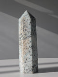 Luxury Kiwi Jasper Tower by Stone and Bloom featuring soft mint green tones, natural quartz inclusions, and charcoal mineral speckling polished into a premium statement piece.