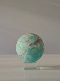 Luxury sparkling Hemimorphite Sphere by Stone and Bloom featuring sky-blue crystal formations, shimmering druzy texture, and premium polished craftsmanship.