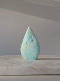 High-grade Hemimorphite flame featuring oceanic aqua and seafoam green banding, natural sculptural cavities, and flowing mineral patterns, photographed in natural light and curated by Stone and Bloom.