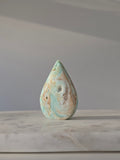 High-grade Hemimorphite flame featuring oceanic aqua and seafoam green banding, natural sculptural cavities, and flowing mineral patterns, photographed in natural light and curated by Stone and Bloom.