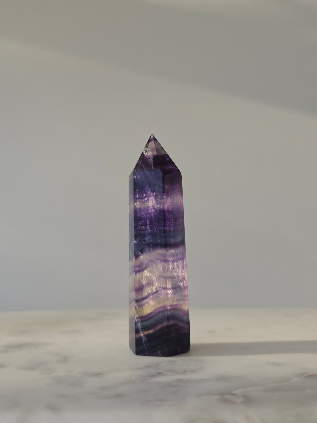 High-grade Rainbow Fluorite crystal tower featuring translucent aqua, mint green, and violet banding with natural internal rainbows and exceptional clarity, curated by Stone and Bloom.