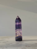 High-grade Rainbow Fluorite crystal tower featuring translucent aqua, mint green, and violet banding with natural internal rainbows and exceptional clarity, curated by Stone and Bloom.