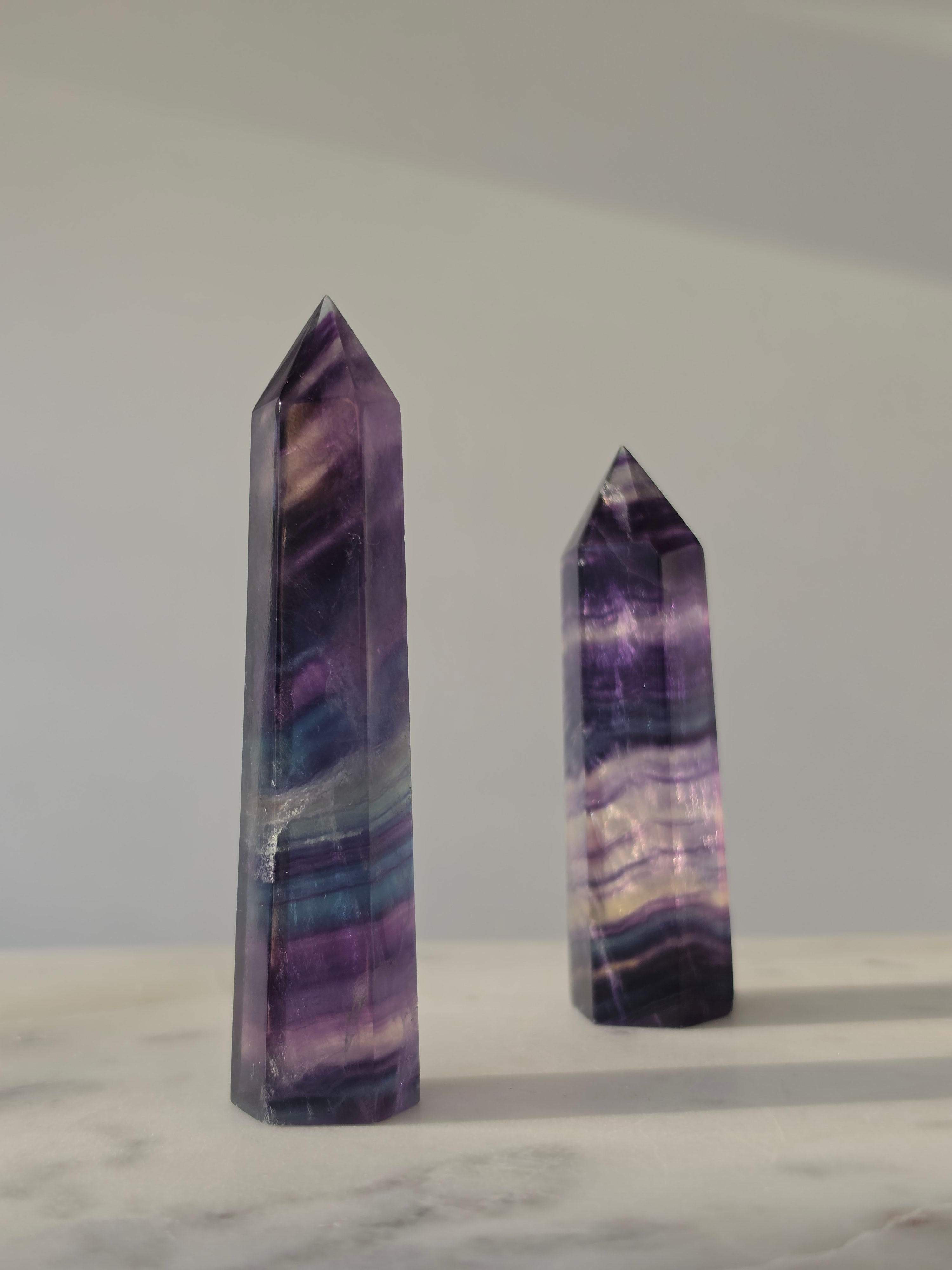 High-grade Rainbow Fluorite crystal tower featuring translucent aqua, mint green, and violet banding with natural internal rainbows and exceptional clarity, curated by Stone and Bloom.