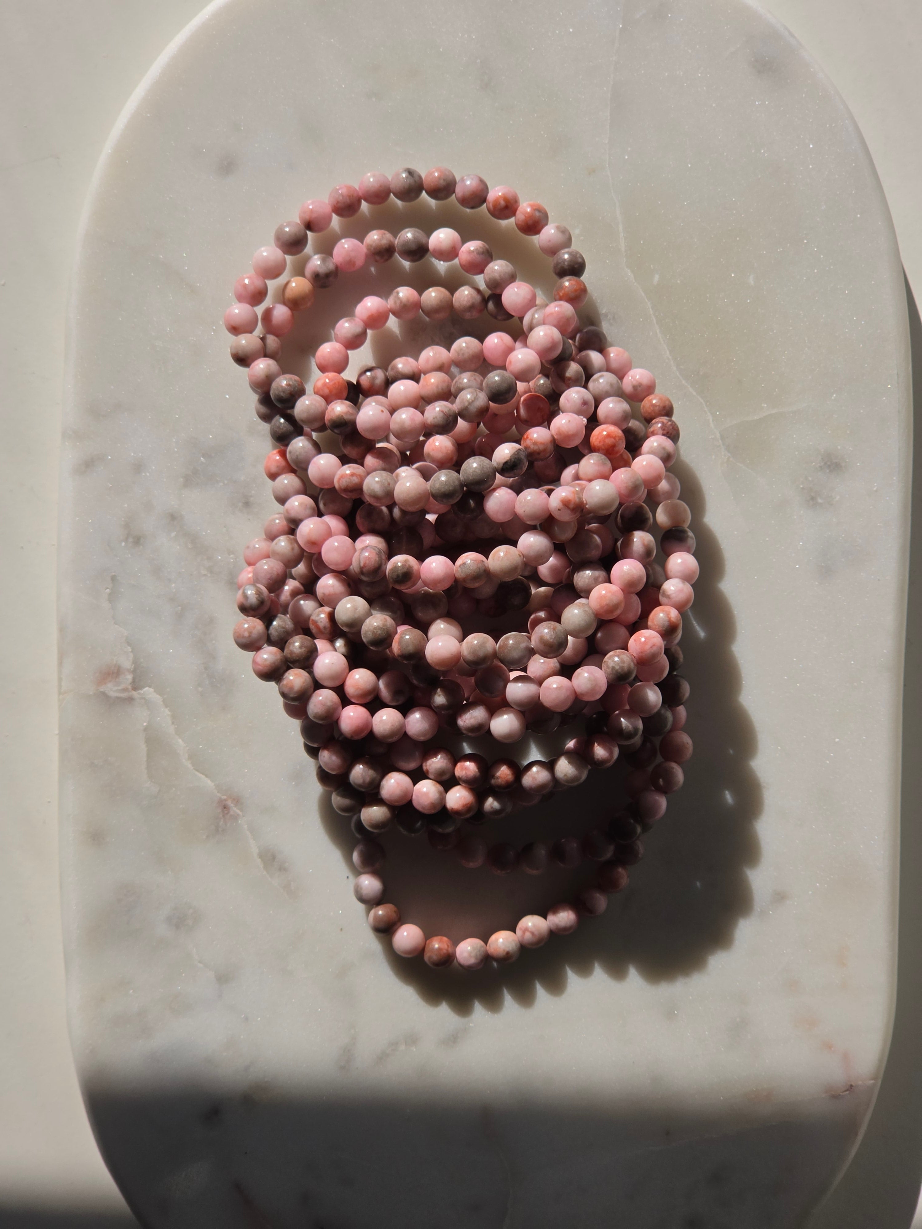 High-grade natural Pink Opal beaded bracelets featuring soft blush pink, dusty rose, mauve, and taupe gemstones with a smooth polished finish, handcrafted with premium quality stones and photographed in natural light.