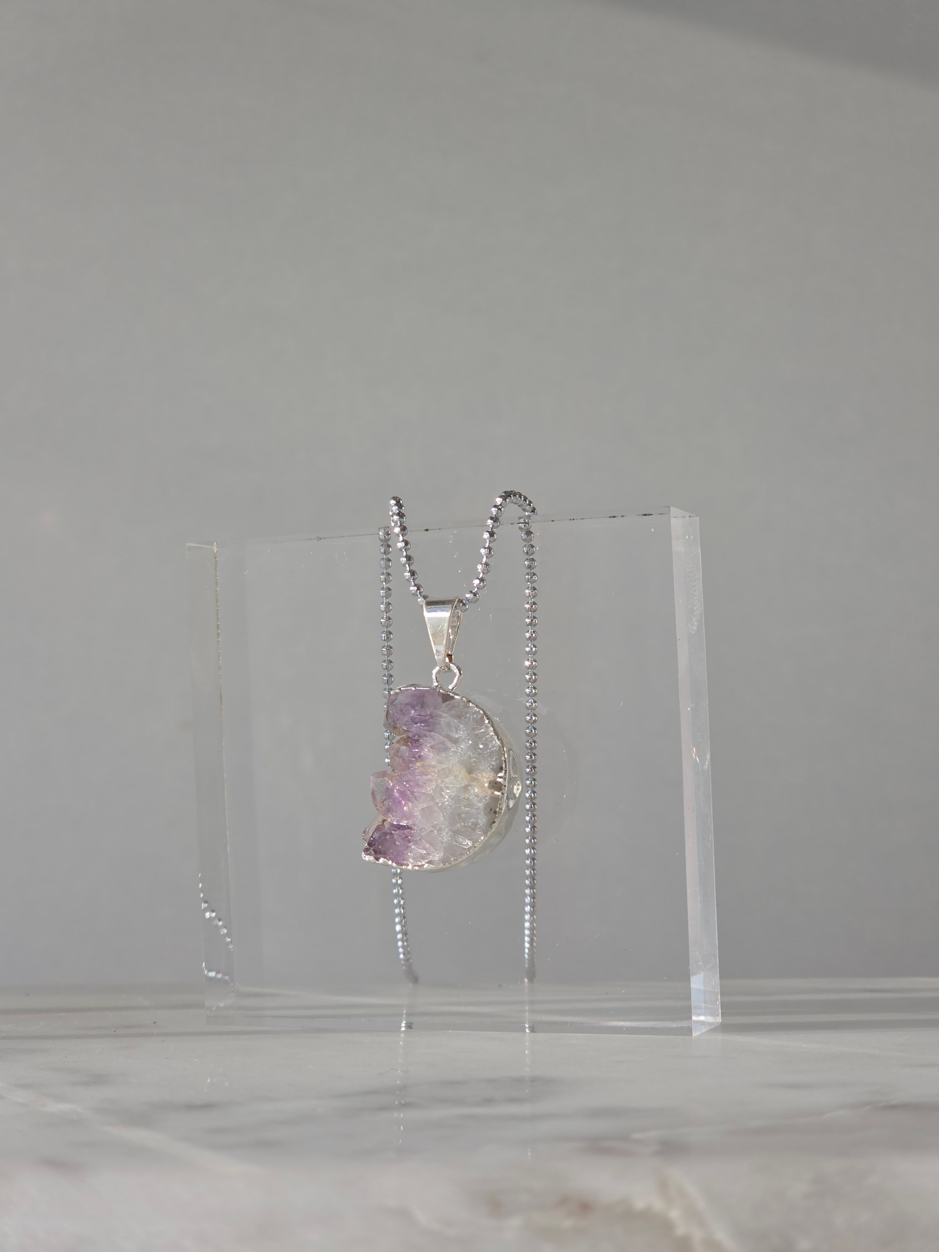 Natural Amethyst Slice Moon Pendant, raw crystal druzy pendant in a silver-plated setting from the Stone & Bloom Raw Luxe Collection.