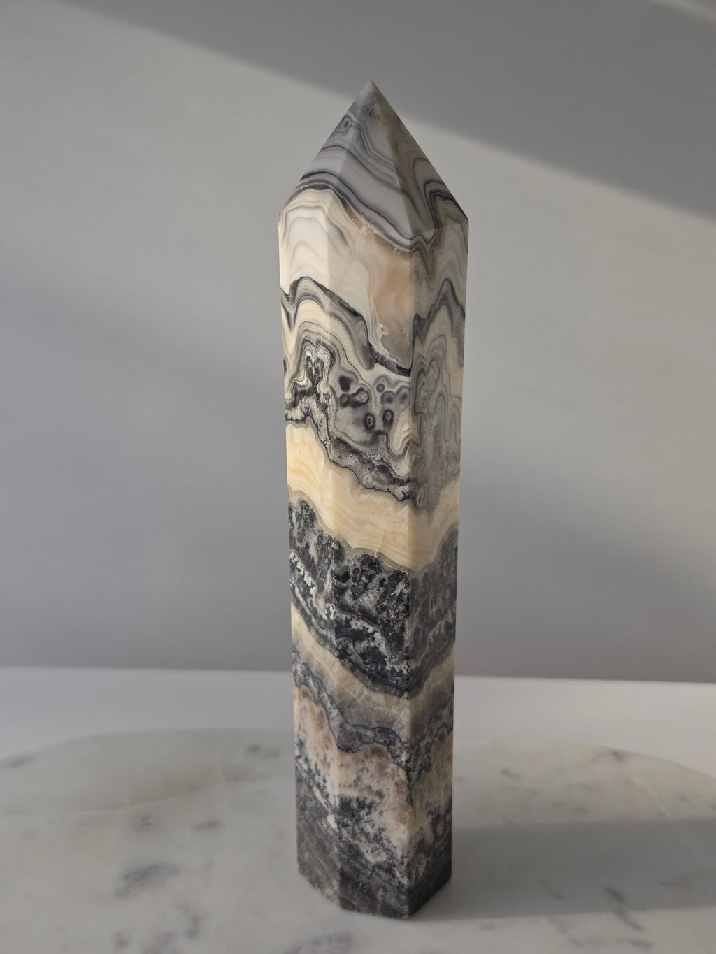 Luxury Chocolate Calcite Tower by Stone and Bloom featuring rich caramel and cream natural banding, Chocolate Calcite Tower, Crystal Tower, Luxury Crystal Décor, Statement Crystal Piece, Stone and Bloom. Home Styling, Natural Stone, On Trend