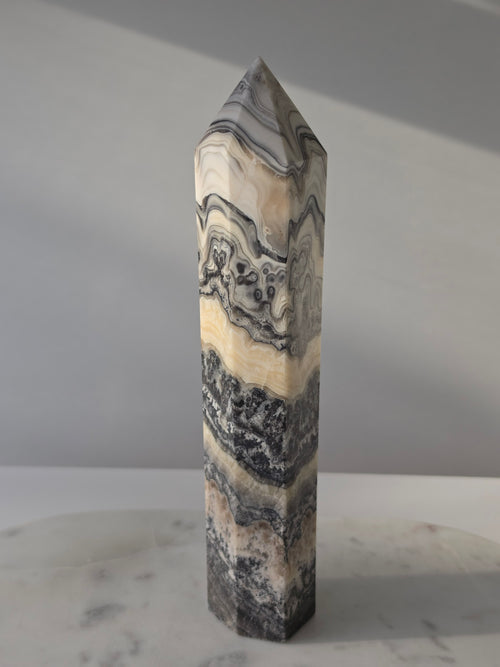 Luxury Chocolate Calcite Tower by Stone and Bloom featuring rich caramel and cream natural banding, Chocolate Calcite Tower, Crystal Tower, Luxury Crystal Décor, Statement Crystal Piece, Stone and Bloom. Home Styling, Natural Stone, On Trend