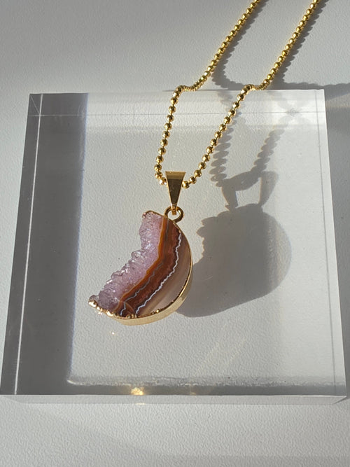 Natural Amethyst Slice Moon Pendant, raw crystal druzy pendant in a gold-plated setting from the Stone & Bloom Raw Luxe Collection.