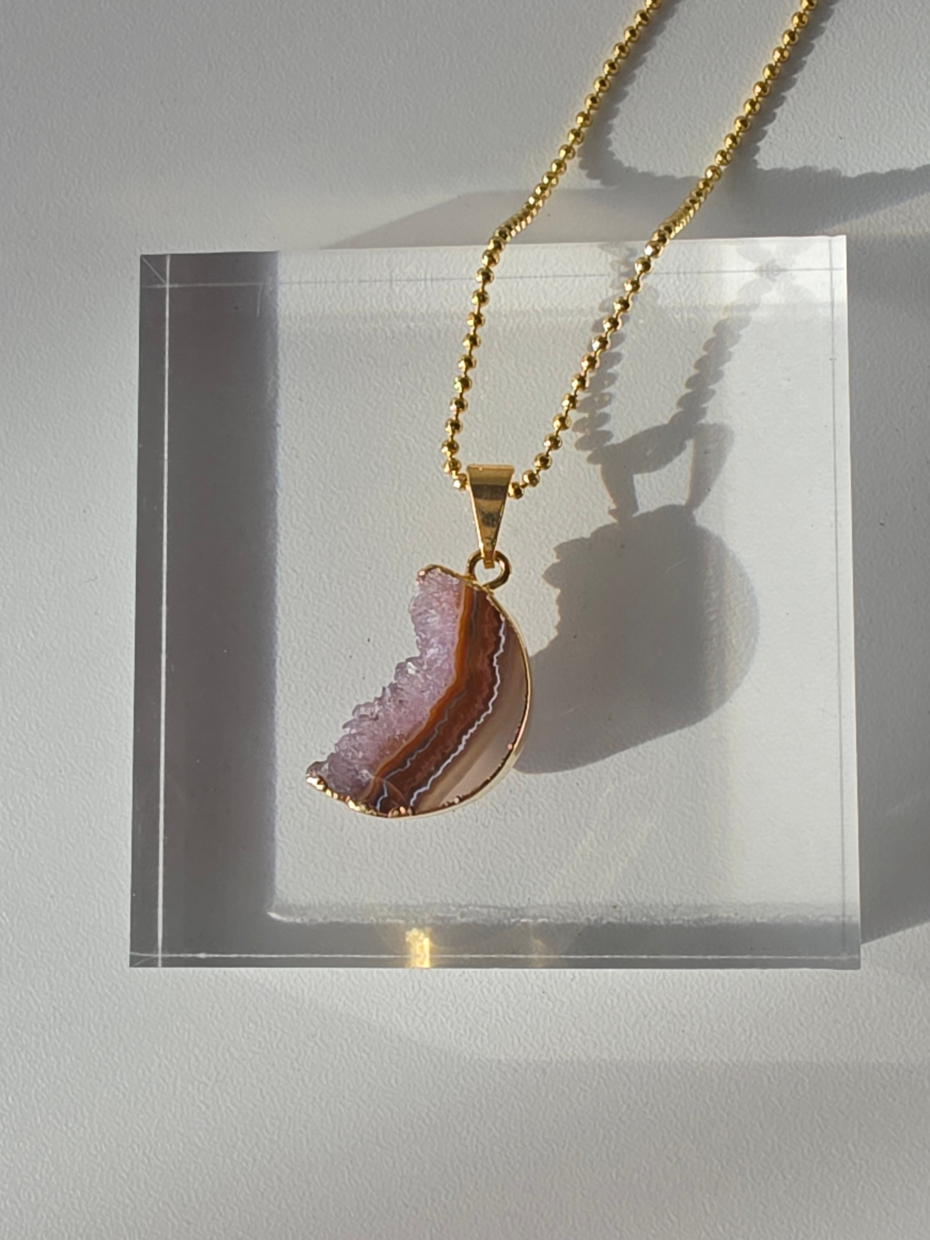 Natural Amethyst Slice Moon Pendant, raw crystal druzy pendant in a gold-plated setting from the Stone & Bloom Raw Luxe Collection.