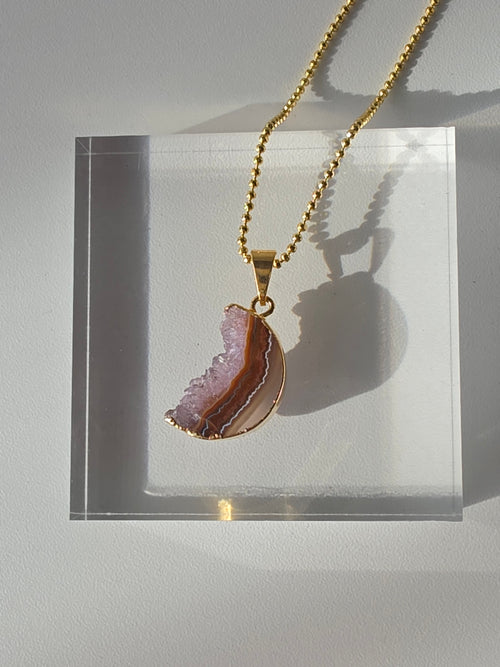 Natural Amethyst Slice Moon Pendant, raw crystal druzy pendant in a gold-plated setting from the Stone & Bloom Raw Luxe Collection.