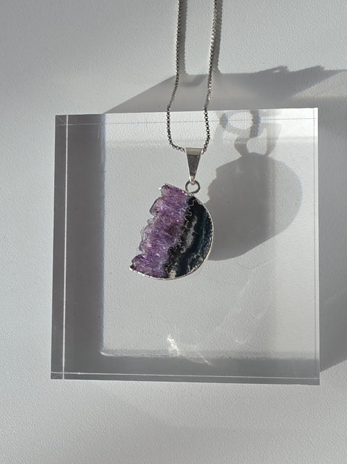Natural Amethyst Slice Moon Pendant, raw crystal druzy pendant in a silver-plated hypoallergenic setting from the Stone & Bloom Raw Luxe Collection.