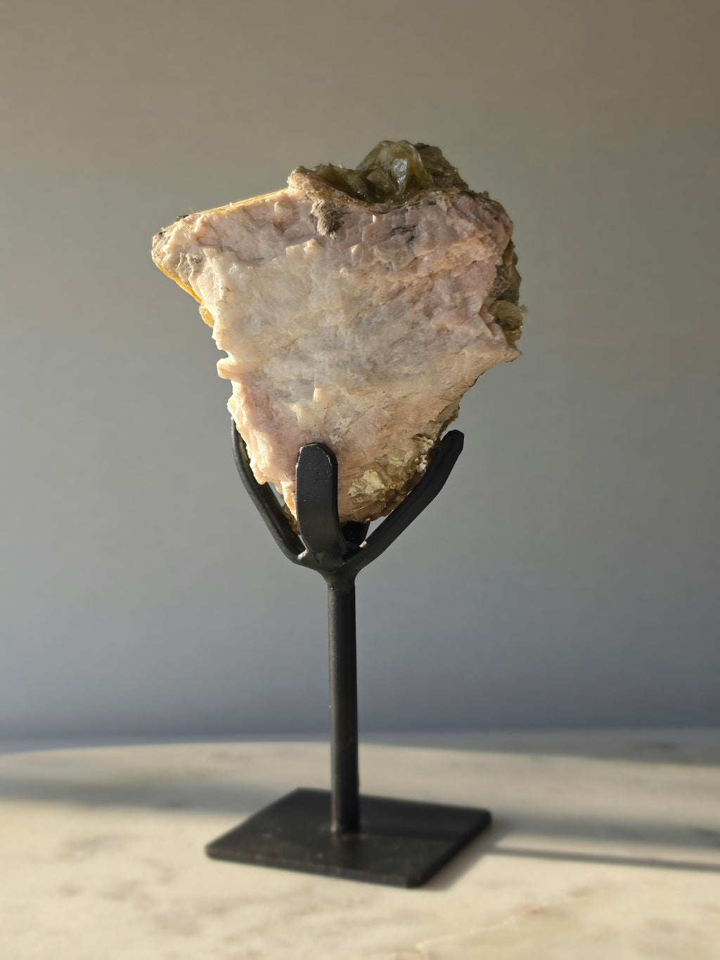 Golden Mica and Black Tourmaline mineral specimen with white Albite matrix displayed on a black metal stand, weighing 460g and measuring 16cm high including stand.