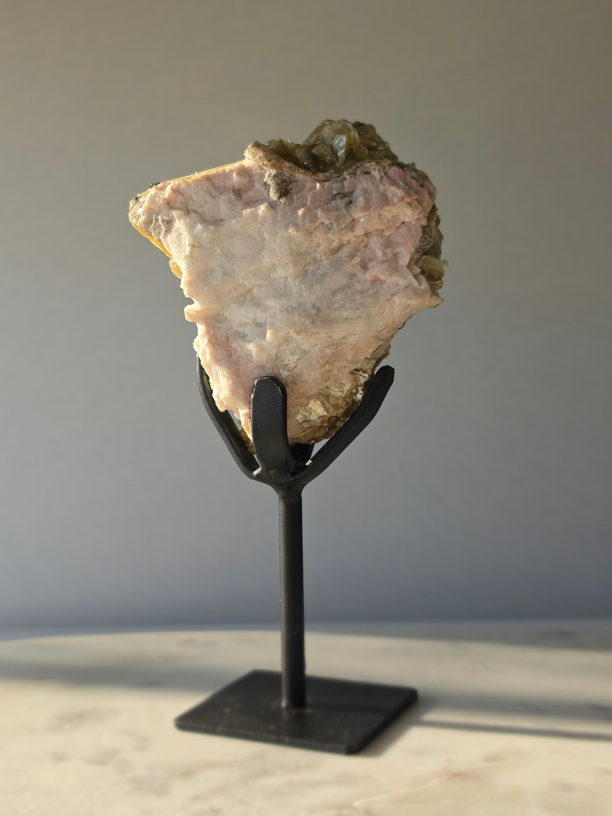 Golden Mica and Black Tourmaline mineral specimen with white Albite matrix displayed on a black metal stand, weighing 460g and measuring 16cm high including stand.