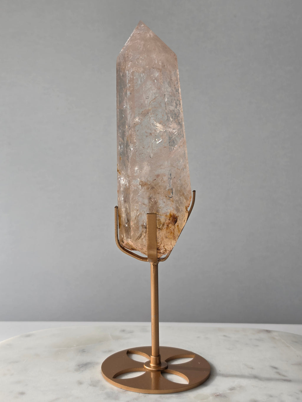 High-grade Nepalese Pink Himalayan Quartz statement point, 626g and 25.5cm tall, featuring soft blush pink tones, natural inclusions and translucent crystal formations, displayed on a gold stand by Stone & Bloom Co.