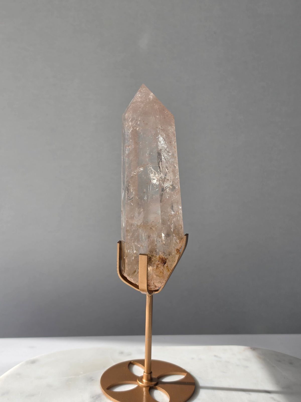 High-grade Nepalese Pink Himalayan Quartz statement point, 626g and 25.5cm tall, featuring soft blush pink tones, natural inclusions and translucent crystal formations, displayed on a gold stand by Stone & Bloom Co.