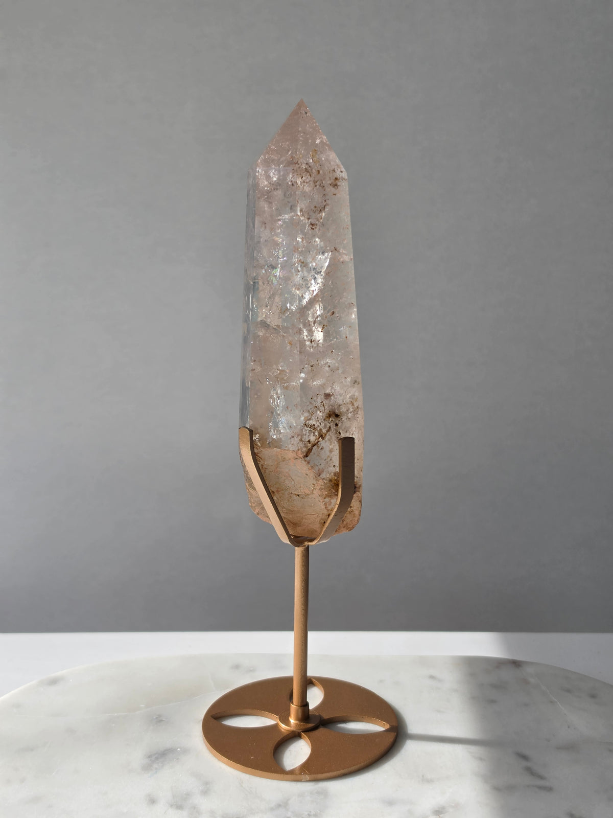 High-grade Nepalese Pink Himalayan Quartz statement point, 626g and 25.5cm tall, featuring soft blush pink tones, natural inclusions and translucent crystal formations, displayed on a gold stand by Stone & Bloom Co.