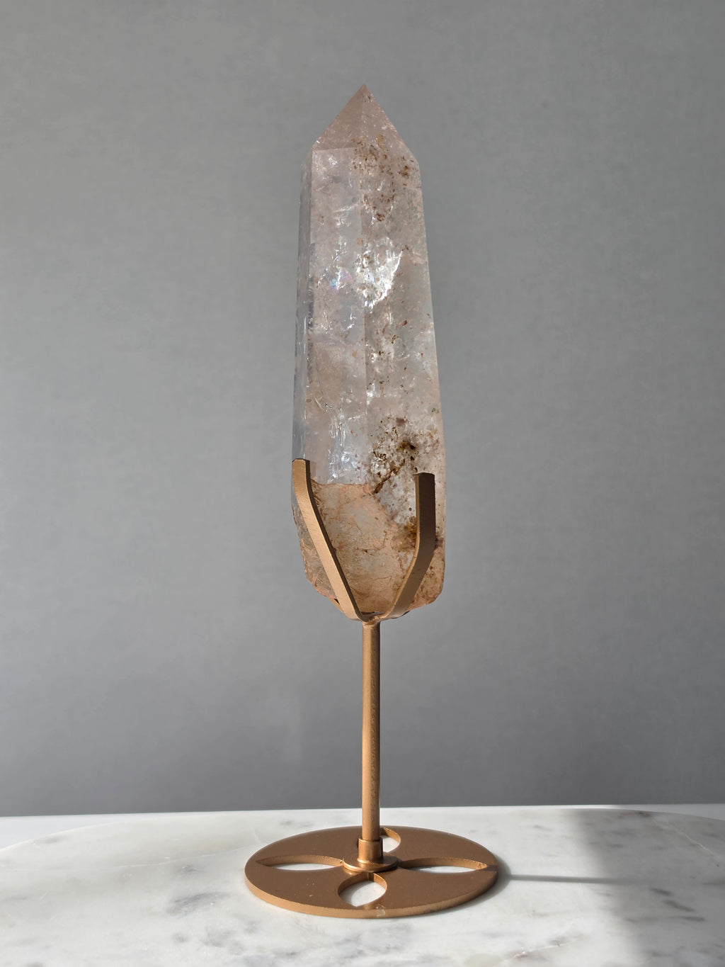 High-grade Nepalese Pink Himalayan Quartz statement point, 626g and 25.5cm tall, featuring soft blush pink tones, natural inclusions and translucent crystal formations, displayed on a gold stand by Stone & Bloom Co.