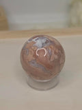 Luxury Candy Agate Sphere by Stone and Bloom featuring soft blush pink and white natural patterns with sparkling druzy,
Candy Agate Sphere
Crystal Sphere
Luxury Crystal Décor
Statement Crystal Piece
Stone and Bloom