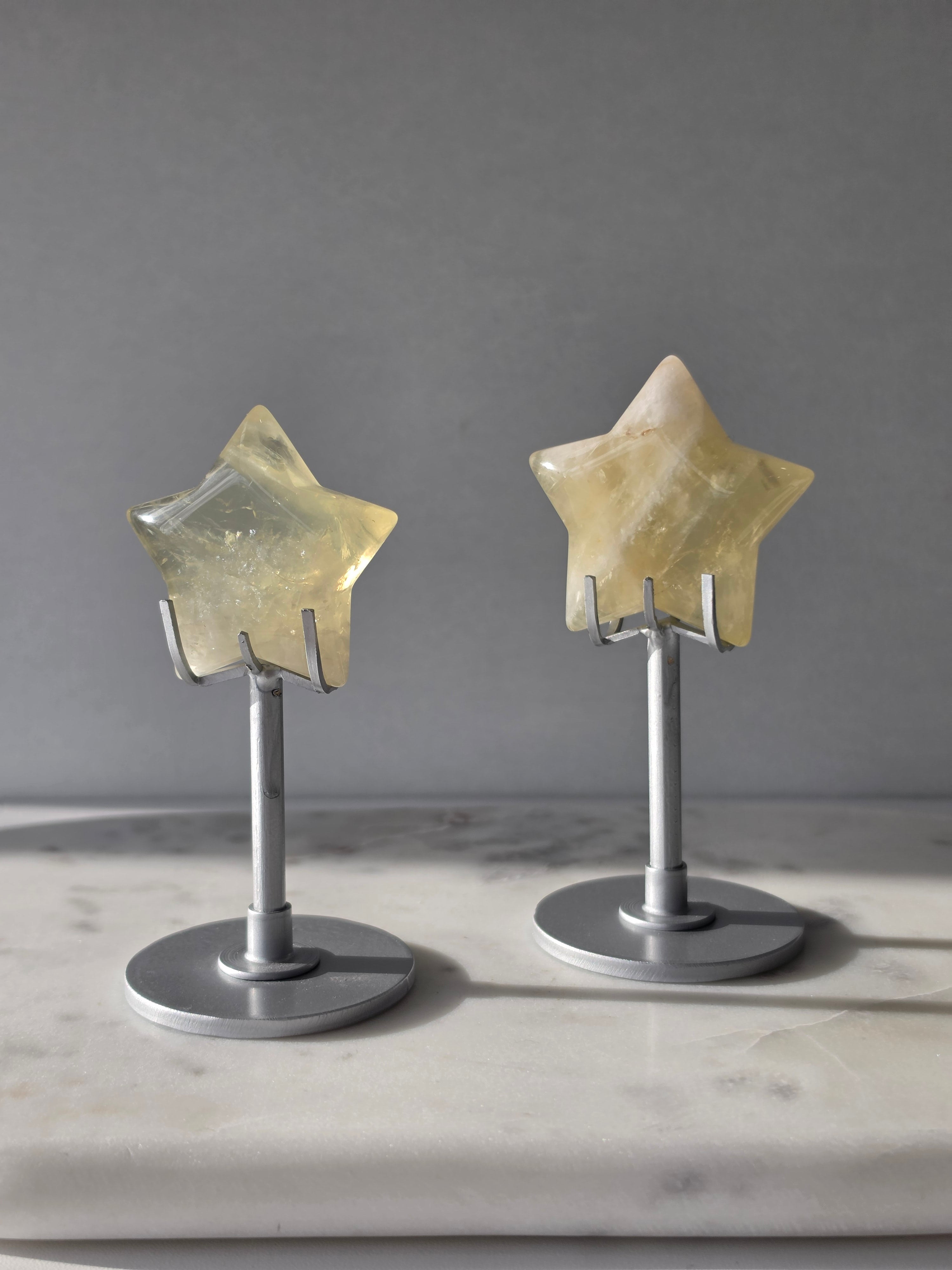 Natural citrine crystal star on a silver stand, featuring translucent golden tones and unique crystal formations, Stone & Bloom statement decor