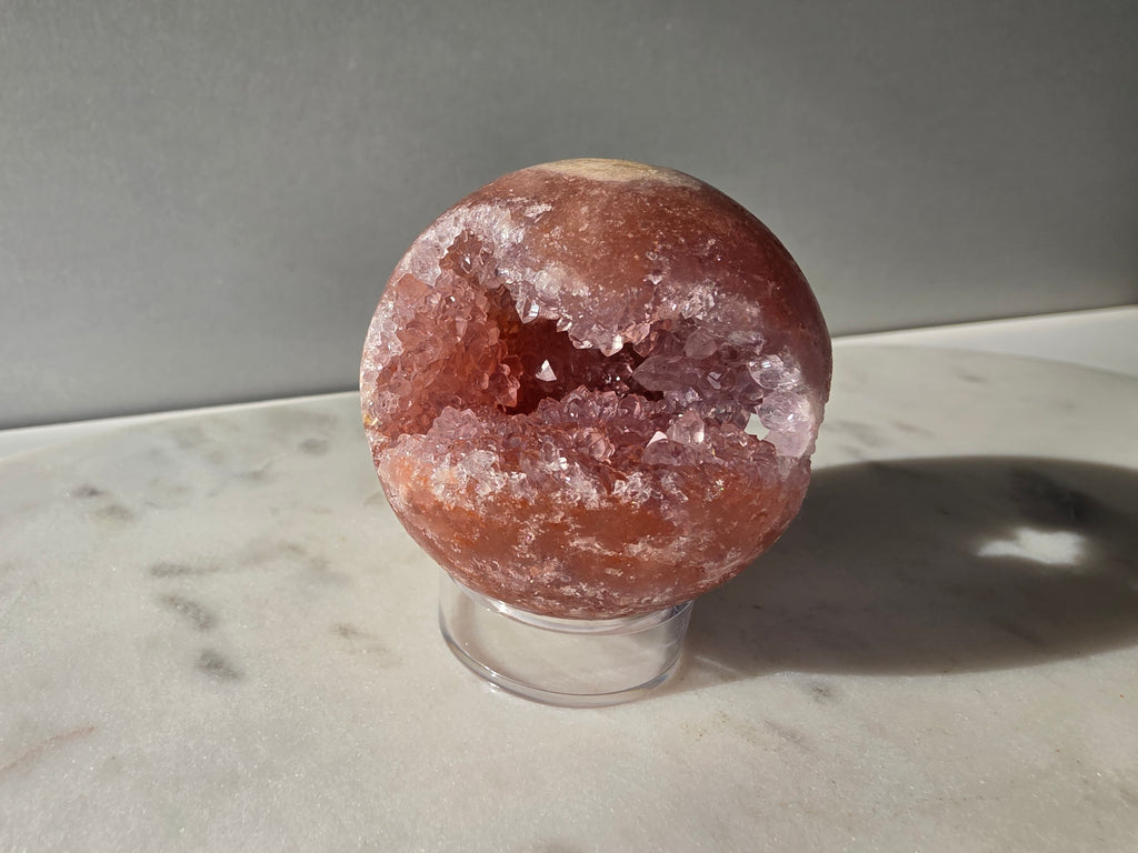Brazilian Pink Amethyst sphere in rich blush and red-pink tones with sparkling druzy crystal formations and a natural crystalline centre, Stone & Bloom