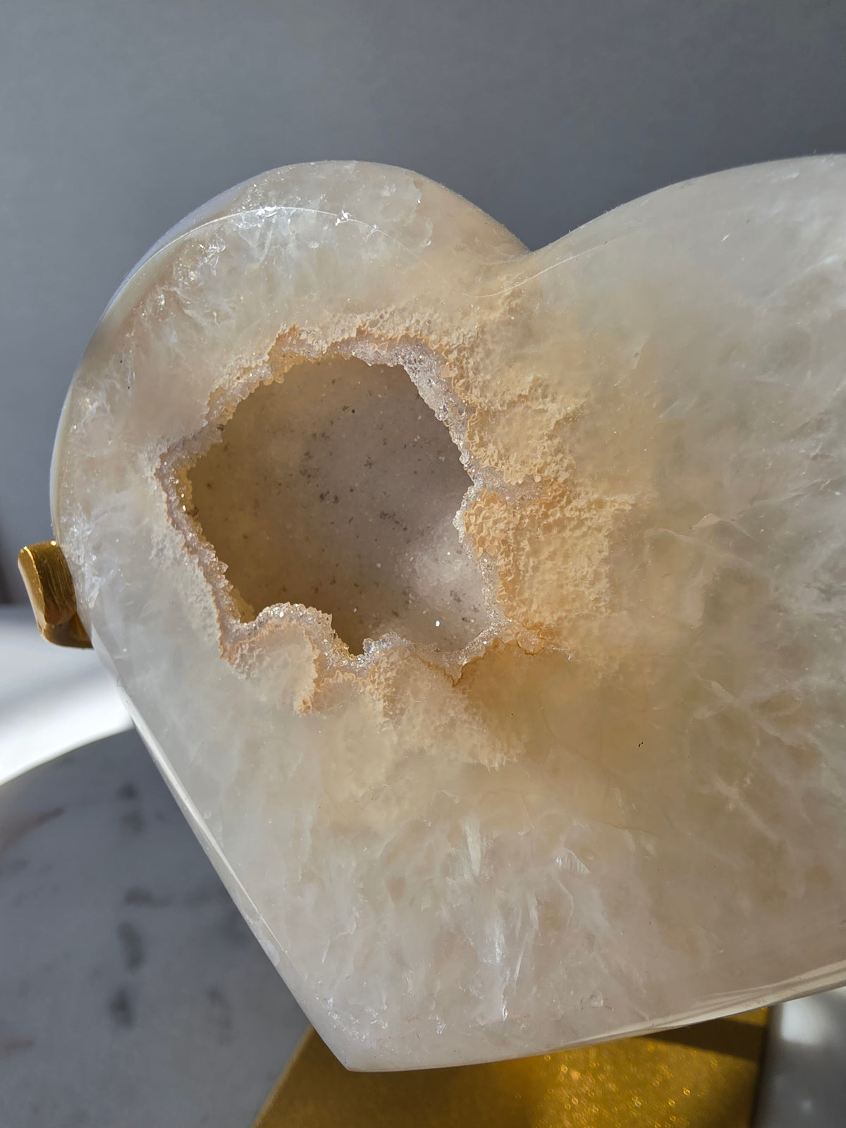 High Clarity Druzy Agate Geode Heart on a gold stand featuring sparkling druzy quartz crystals and natural champagne, caramel, ivory, taupe and smoky-grey agate banding.