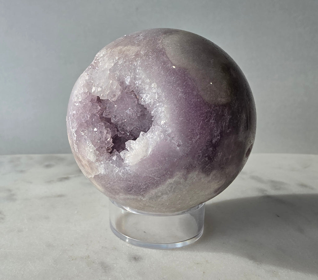 Brazilian Pink Amethyst sphere in soft lilac and lavender tones featuring a sparkling druzy cavity with a natural amethyst flower formation